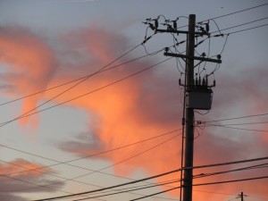 Silhouette of utility pole at sunset